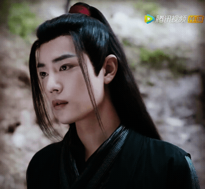 A Close Up Of A Man 'S Face With Chinese Characters On The Bottom GIF