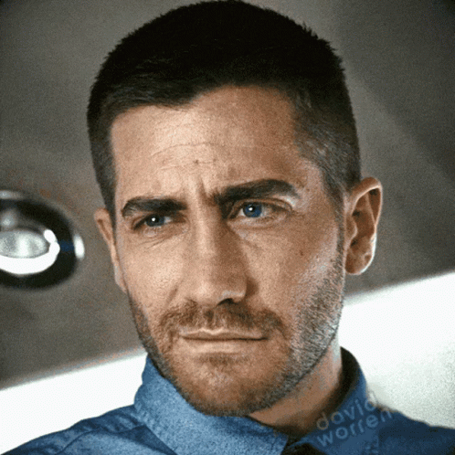 A Close Up Of A Man 'S Face With David Worren Written On The Bottom Right GIF