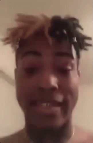 A Close Up Of A Man 'S Face With Dreadlocks On His Head . GIF