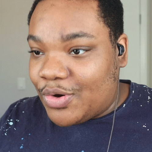 A Close Up Of A Man 'S Face With Ear Buds On GIF
