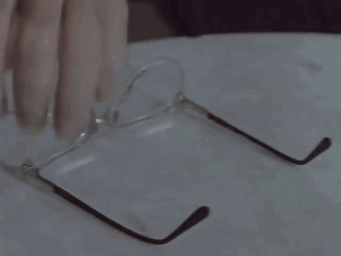 A Close Up Of A Man 'S Face With Glasses GIF