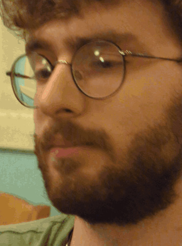 A Close Up Of A Man 'S Face With Glasses On GIF