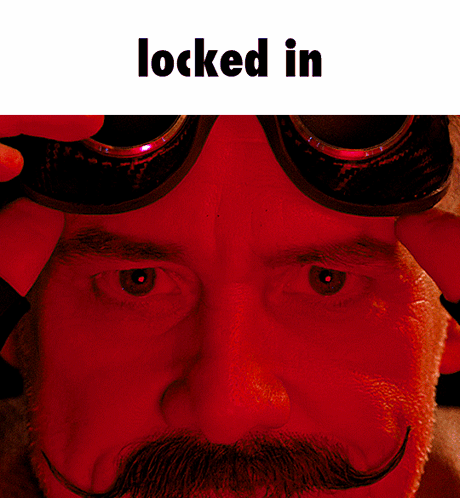 A Close Up Of A Man 'S Face With Goggles On And The Words Locked In Above Him GIF