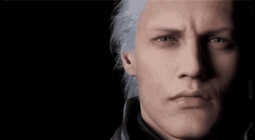 A Close Up Of A Man 'S Face With Gray Hair And Blue Eyes . GIF