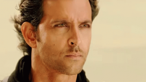 A Close Up Of A Man 'S Face With Green Eyes GIF