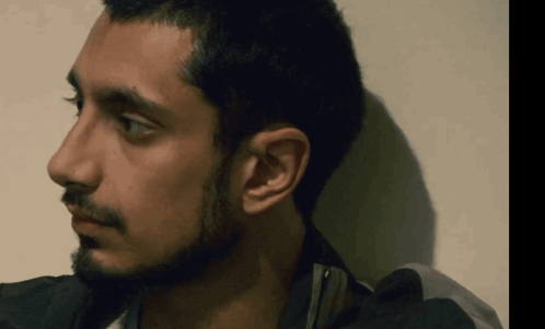 A Close Up Of A Man 'S Face With His Eyes Closed GIF