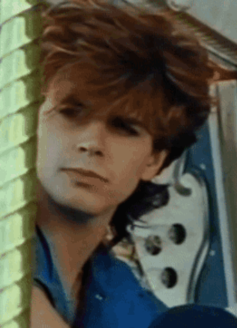 A Close Up Of A Man 'S Face With His Eyes Closed GIF