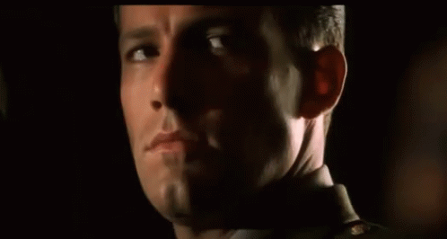 a close up of a man 's face with his eyes closed
