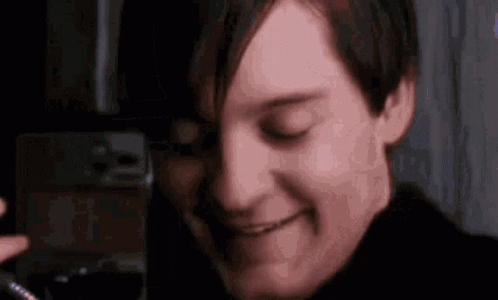 A Close Up Of A Man 'S Face With His Eyes Closed And A Smile On His Face . GIF