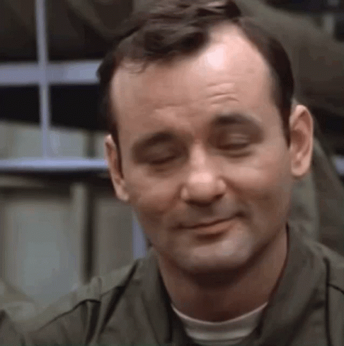 A Close Up Of A Man 'S Face With His Eyes Closed And A Smile On His Face . GIF