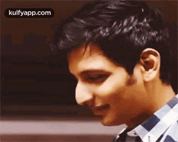 A Close Up Of A Man 'S Face With His Eyes Closed And A Smile On His Face . GIF