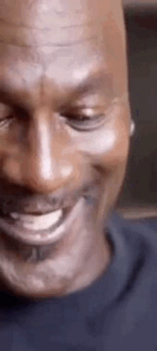 A Close Up Of A Man 'S Face With His Eyes Closed And A Smile On His Face . GIF