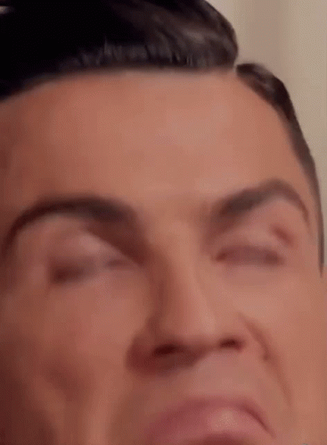 A Close Up Of A Man 'S Face With His Eyes Closed And His Mouth Open . GIF