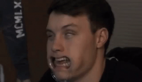 A Close Up Of A Man 'S Face With His Eyes Closed And His Mouth Open . GIF