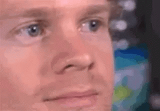 A Close Up Of A Man 'S Face With His Eyes Closed And His Mouth Open . GIF