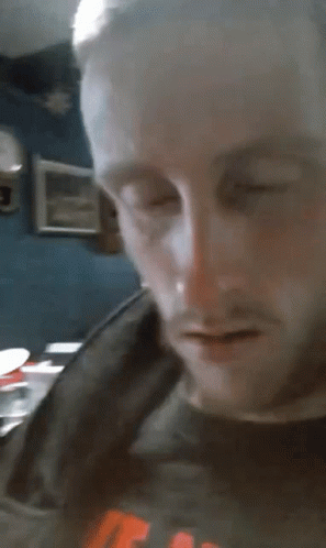 A Close Up Of A Man 'S Face With His Eyes Closed And His Mouth Open GIF