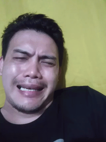 A Close Up Of A Man 'S Face With His Eyes Closed And His Mouth Open GIF