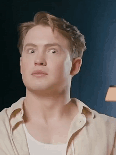 A Close Up Of A Man 'S Face With His Eyes Closed And His Mouth Open . GIF