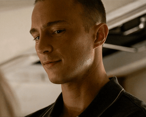 a close up of a man 's face with his eyes closed and his mouth open