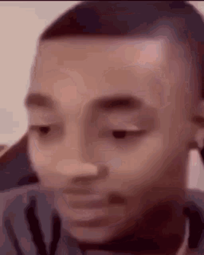 A Close Up Of A Man 'S Face With His Eyes Closed And His Mouth Open . GIF