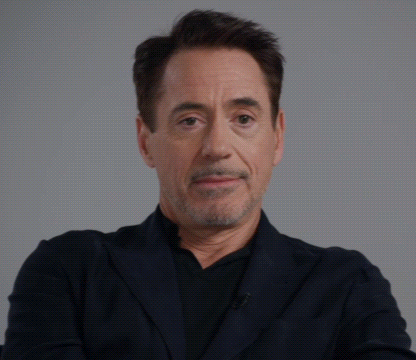 A Close Up Of A Man 'S Face With His Eyes Closed And His Mouth Open GIF