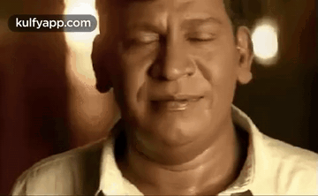 A Close Up Of A Man 'S Face With His Eyes Closed And His Mouth Open . GIF