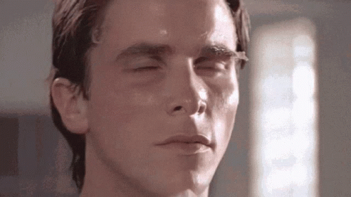 A Close Up Of A Man 'S Face With His Eyes Closed And His Mouth Open . GIF
