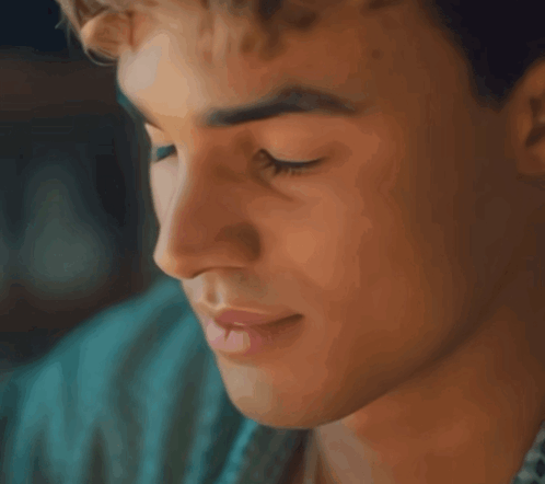 A Close Up Of A Man 'S Face With His Eyes Closed And His Mouth Open GIF