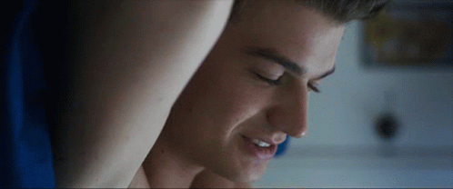 A Close Up Of A Man 'S Face With His Eyes Closed And Smiling GIF