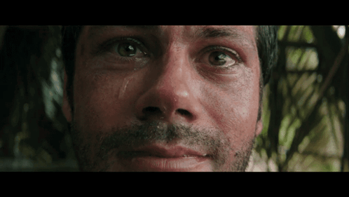 a close up of a man 's face with his eyes closed