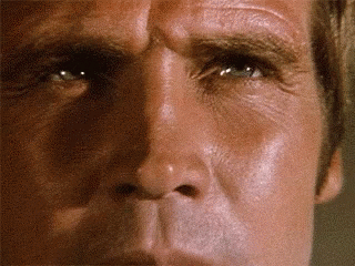 A Close Up Of A Man 'S Face With His Eyes Closed GIF