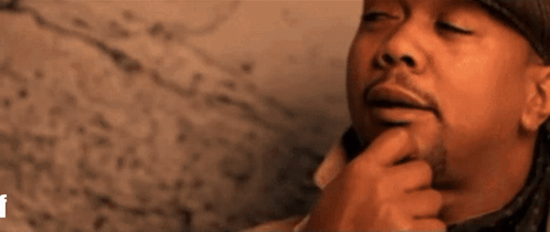 A Close Up Of A Man 'S Face With His Eyes Closed GIF