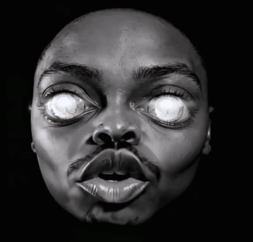 a close up of a man 's face with his eyes glowing