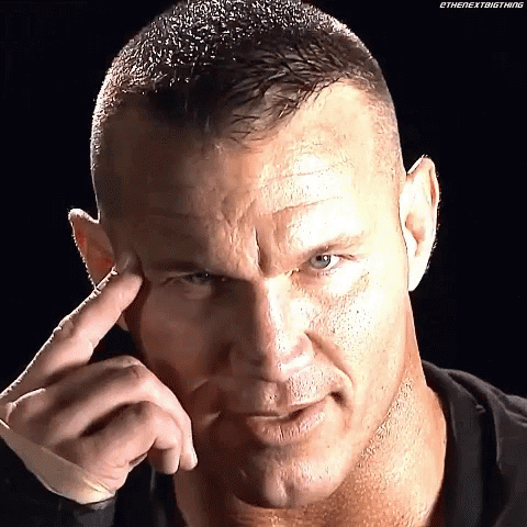 A Close Up Of A Man 'S Face With His Finger To His Forehead . GIF