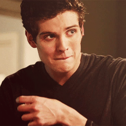 A Close Up Of A Man 'S Face With His Hand On His Chin GIF