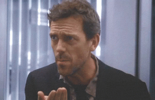 A Close Up Of A Man 'S Face With His Hands Out GIF