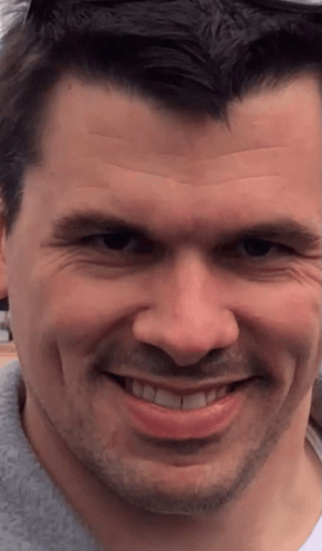 A Close Up Of A Man 'S Face With His Mouth Open GIF