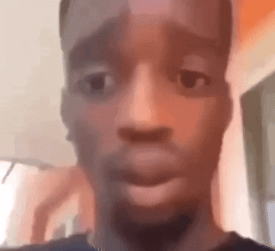 a close up of a man 's face with his mouth open and a blurry background .