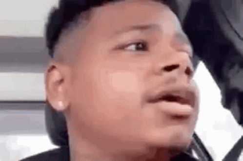 A Close Up Of A Man 'S Face With His Mouth Open And A Hat On . GIF