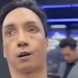 A Close Up Of A Man 'S Face With His Mouth Open And A Man In The Background . GIF