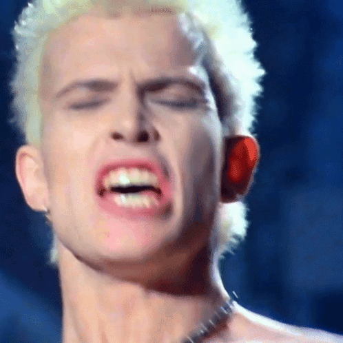 A Close Up Of A Man 'S Face With His Mouth Open And His Eyes Closed GIF