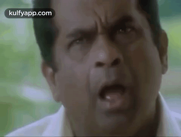 A Close Up Of A Man 'S Face With His Mouth Open And His Eyes Closed . GIF