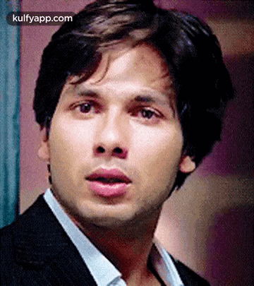 A Close Up Of A Man 'S Face With His Mouth Open And His Eyes Closed . GIF