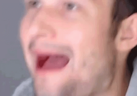 A Close Up Of A Man 'S Face With His Mouth Open And His Eyes Closed . GIF