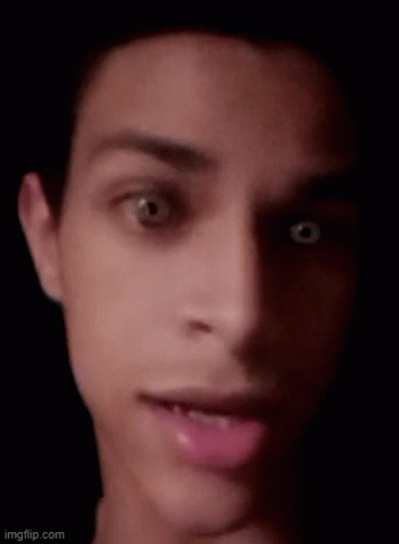 A Close Up Of A Man 'S Face With His Mouth Open And His Eyes Looking At The Camera . GIF
