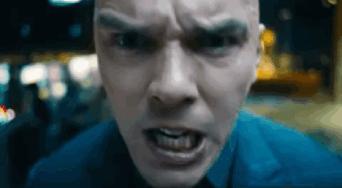 A Close Up Of A Man 'S Face With His Mouth Open And His Teeth Showing . GIF