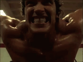 A Close Up Of A Man 'S Face With His Mouth Open And His Teeth Showing . GIF