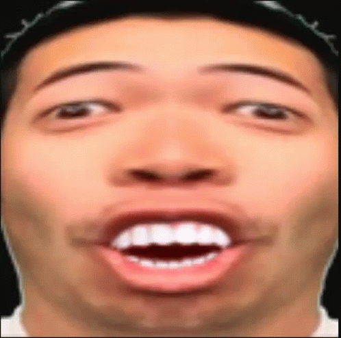 A Close Up Of A Man 'S Face With His Mouth Open And His Teeth Visible . GIF