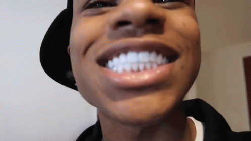 A Close Up Of A Man 'S Face With His Mouth Open And His Teeth Visible . GIF