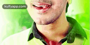 A Close Up Of A Man 'S Face With His Mouth Open And His Tongue Sticking Out . GIF